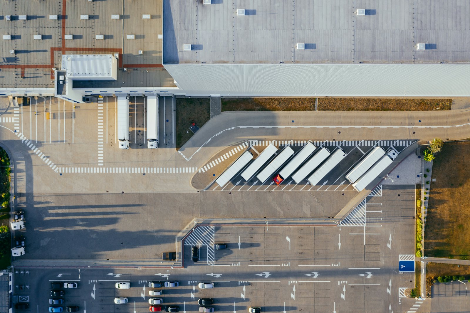 Aerial view of a distribution center with trailers at its dock doors