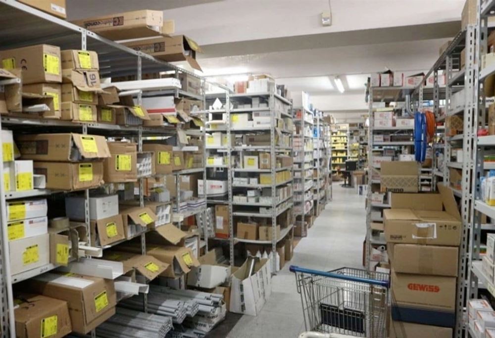Long aisles of static shelving with cartons and parts