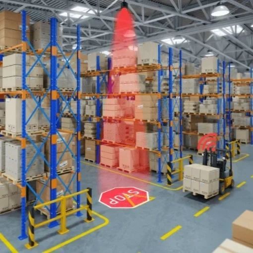 A STOP sign projected at a racking aisle end as a forklift approaches